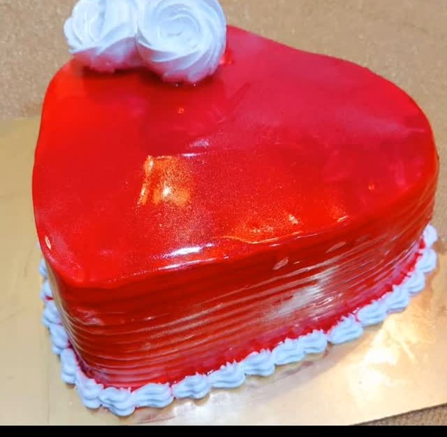 Red mirror-glaze heart cake with cream roses