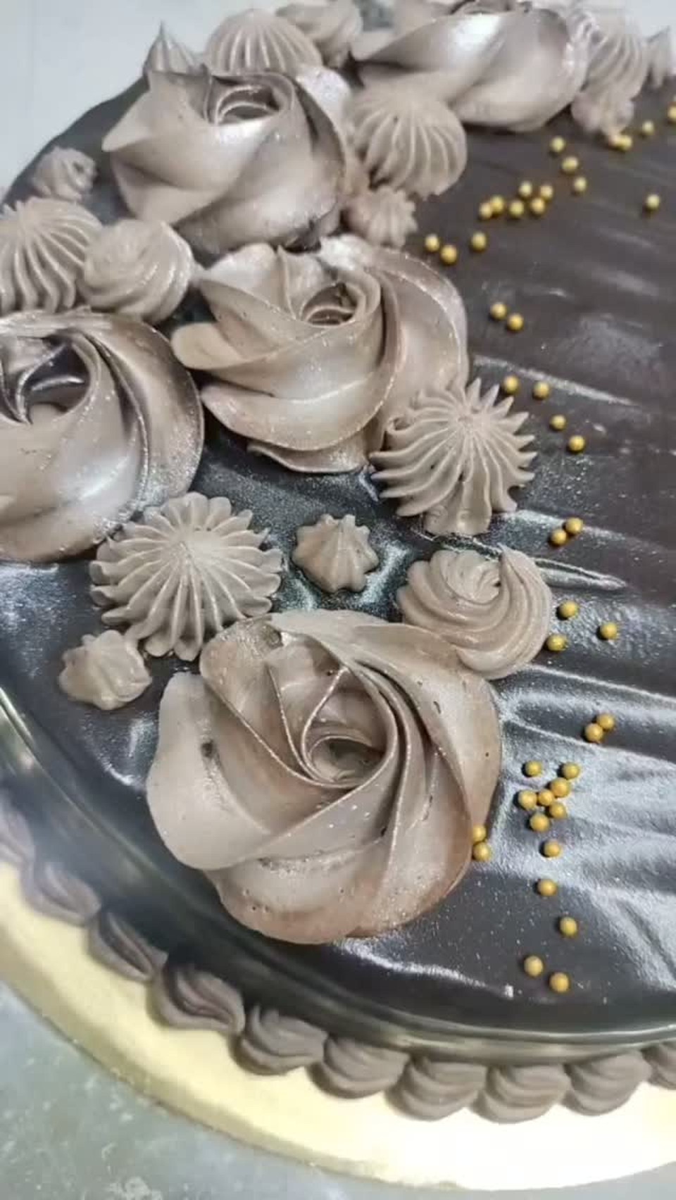 Dark chocolate cake with hand-piped mocha rosettes